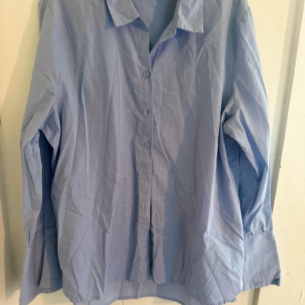 Women’s button up dress shirt with flared cuffs.